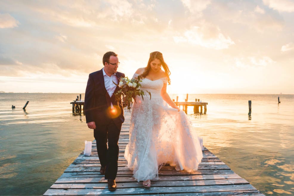 novios caminando por muelle en isla mujeres